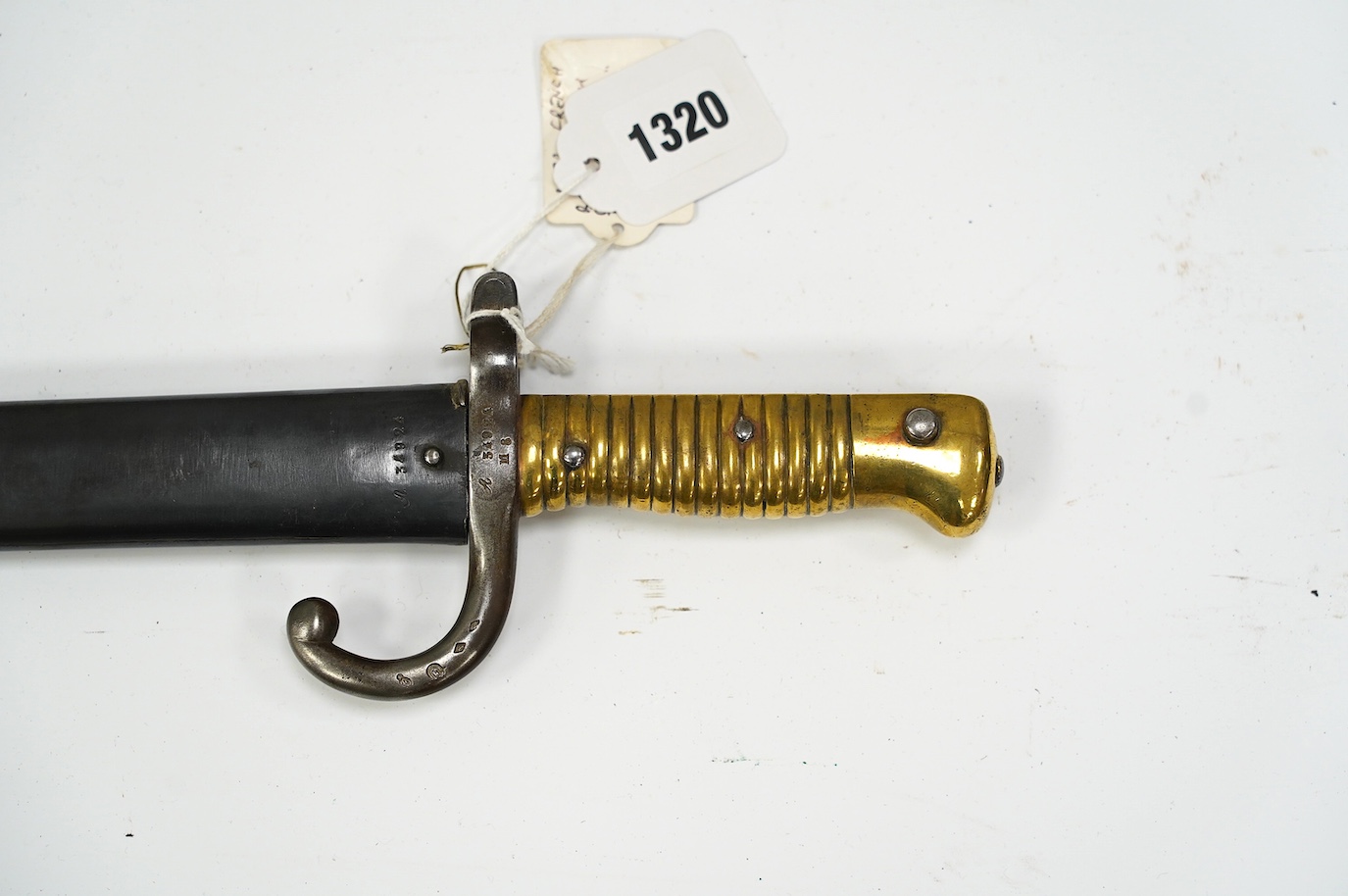 A Chassepot French bayonet in its steel scabbard, dated 1872. Condition - good